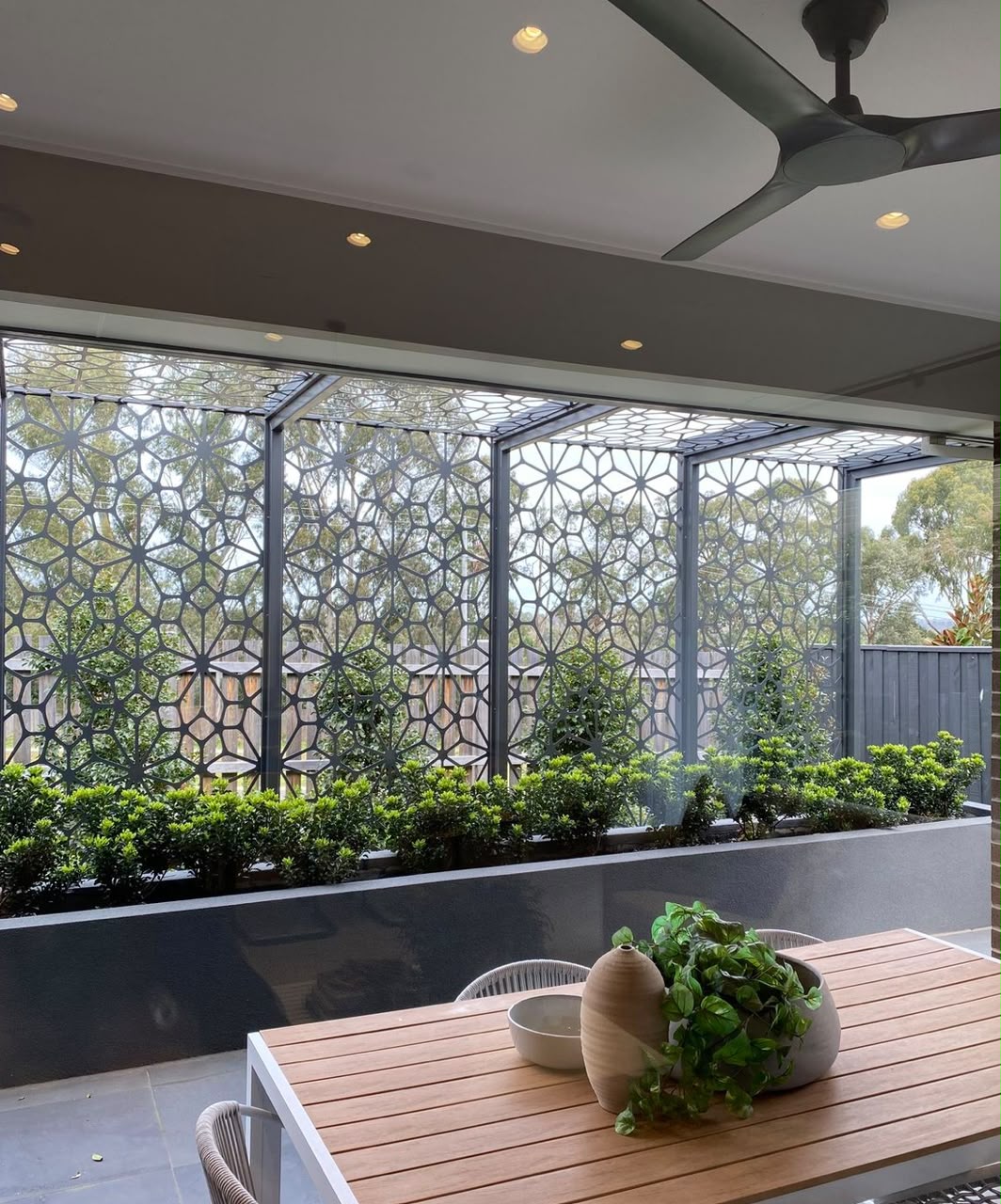 Laser-cut geometric privacy screens on a patio